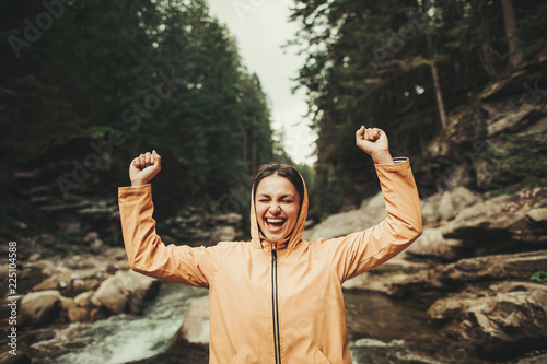 Overjoyed delighted woman expressing gladness while resting in the forest