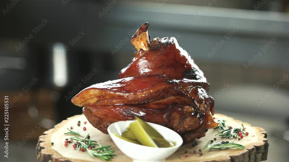 Roasted pork shank with vegetables. Meat and sliced pickles.