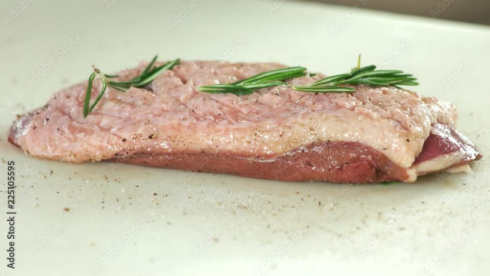 Raw meat with rosemary. Uncooked duck breast. Raw meat with rosemary. Uncooked duck breast.