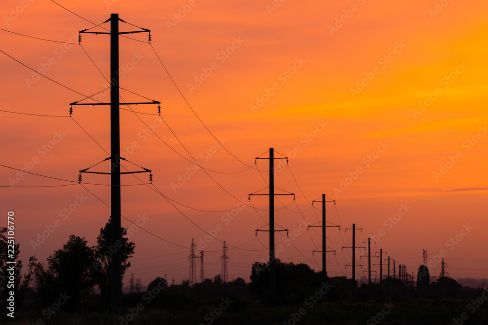 Rural landscape with high-voltage line on sunset