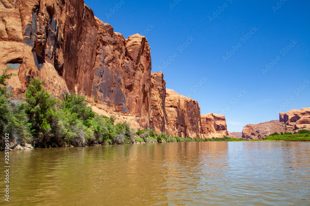 Water view from the Colorado River along the bluffs and rock sculpture outside Moab, Utah