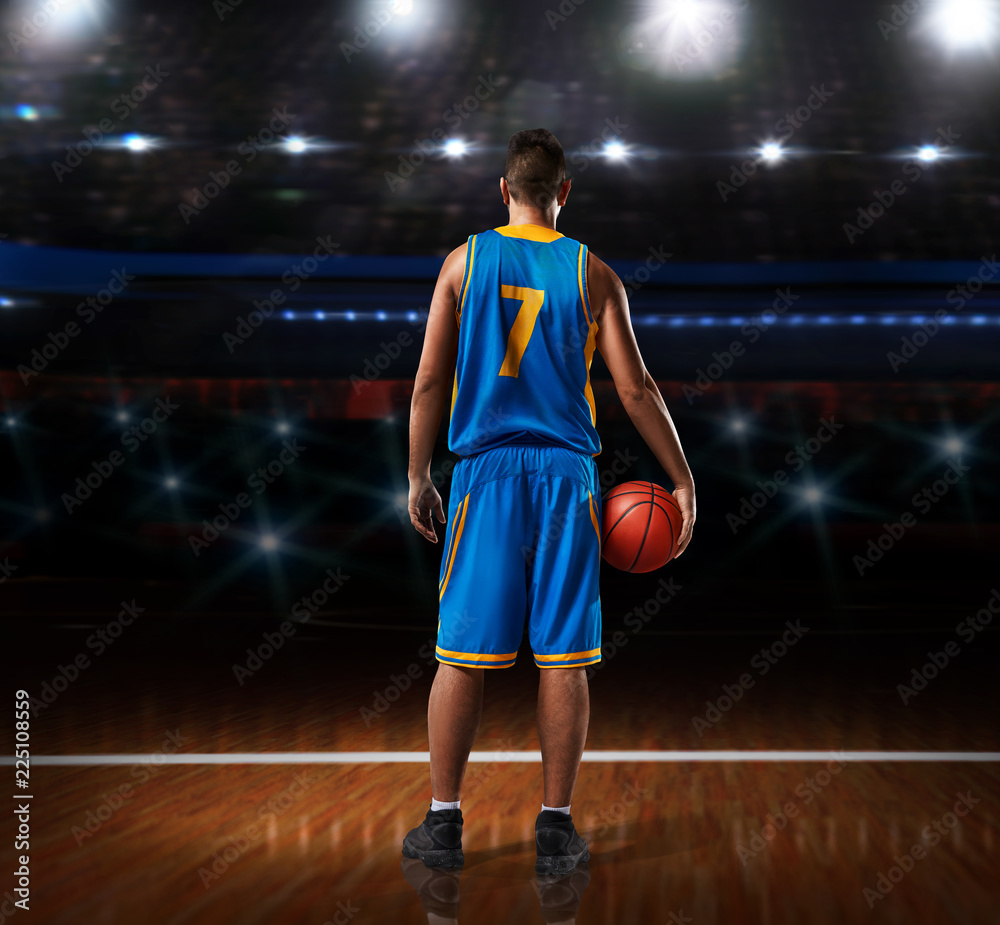 basketball player in blue uniform standing on basketball court