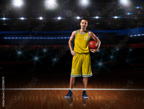 basketball player in yellow uniform standing on basketball court