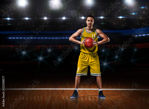 basketball player in yellow uniform standing on basketball court © 27mistral