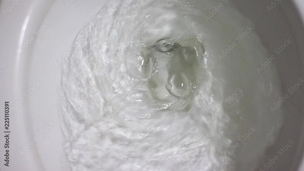 Press Cleaning toilet and flushed water in bathroom. Press Cleaning toilet and flushed water in bathroom.