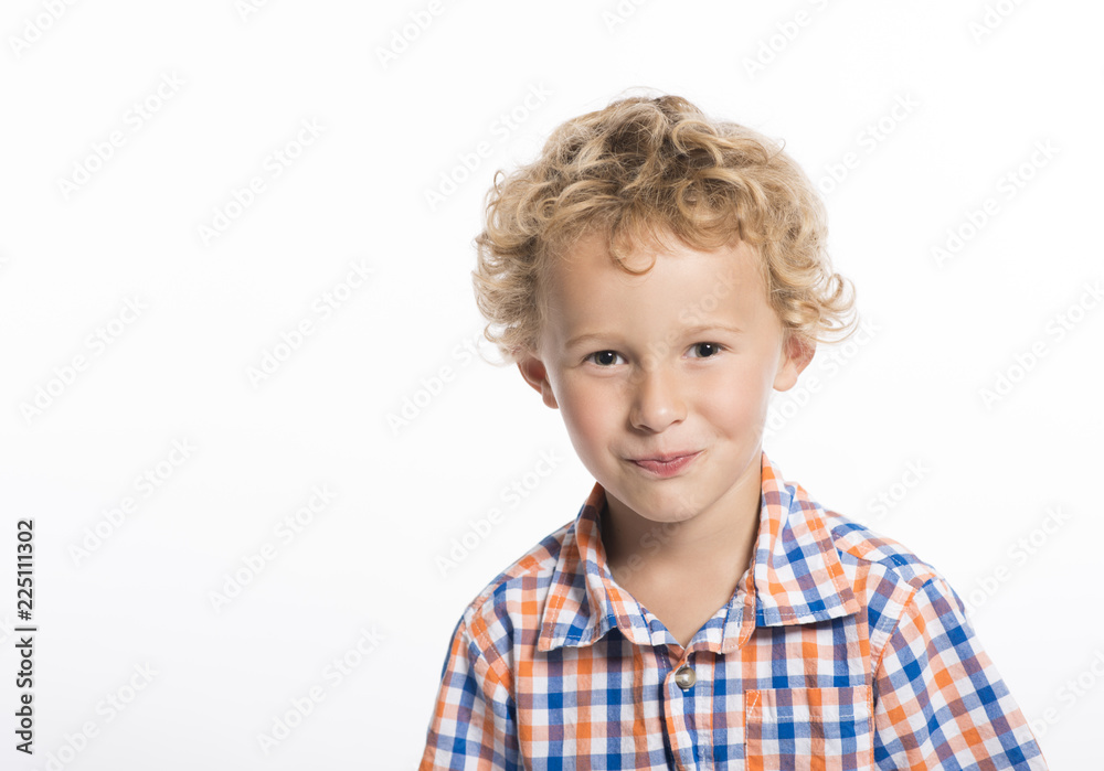 Adorable, curly haired little boy trying not to laugh, isolated on white background Adorable, curly haired little boy trying not to laugh, isolated on white background
