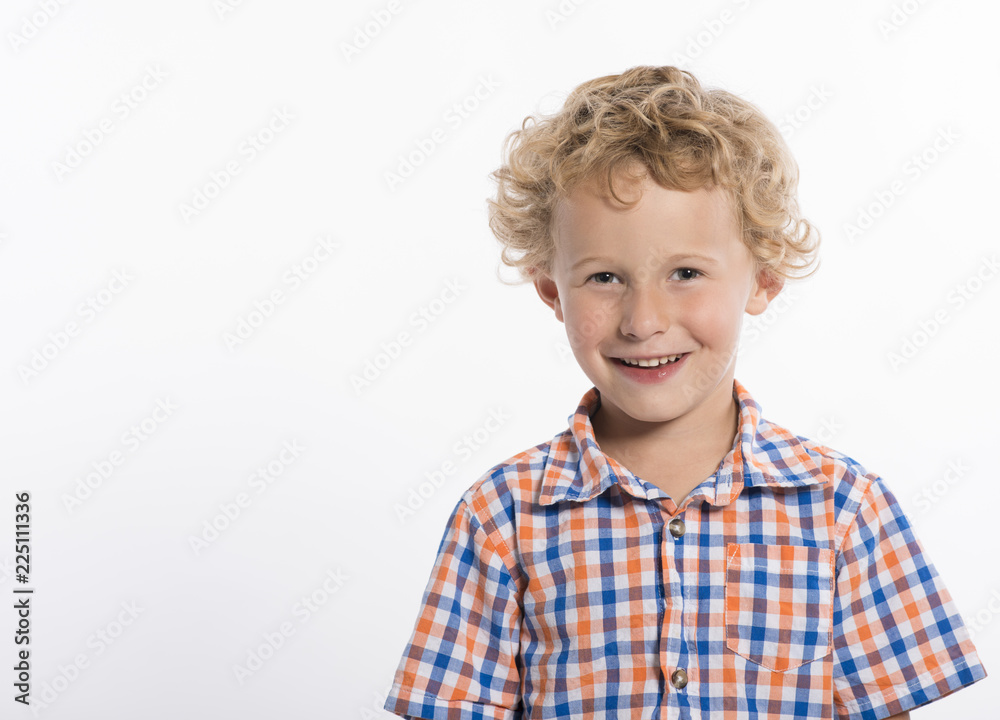 Adorable little boy in plaid shirt on white background, smiling at camera