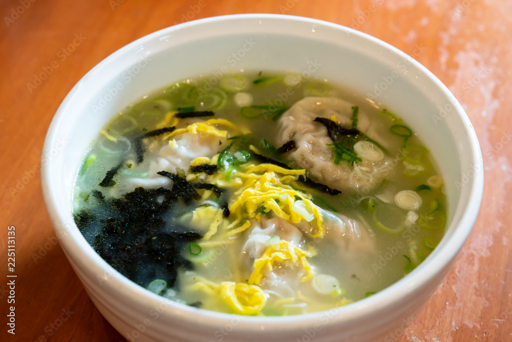 Korean dumpling soup with garnish such as fried eggs, Welsh onion, dried laver. Korean dumpling soup with garnish such as fried eggs, Welsh onion, dried laver.
