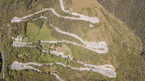 Up and down drone aerial view of the mountain road in Italy that connects the village of Nebro to Selvino. Amazing aerial view of the mountain bends creating beautiful shapes photo