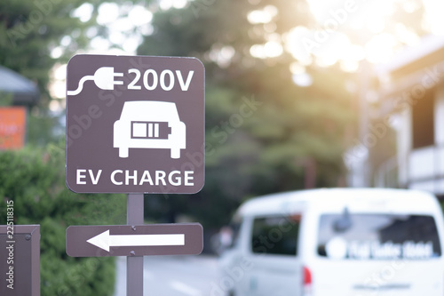 It was shot in Japan Prefecture. Background is the mountain and the bridge and the trees and the road. / EV QUICK Charging Point Sign Boad / eco, sign