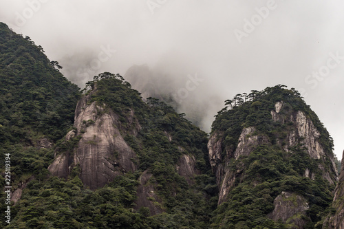 green covered mountain peaks under the thick mist