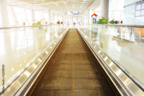 walkway escalator in airport terminal