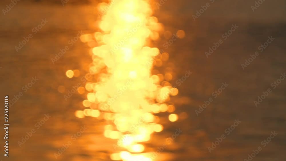 Motion video of defocus water surface with out of focus bokeh of sun glares in twilight time (Blur background Video)