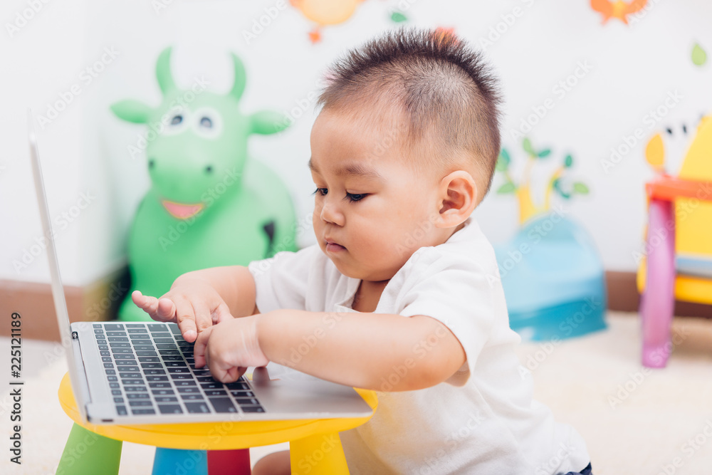 Child baby boy working using laptop computer Child baby boy working using laptop computer