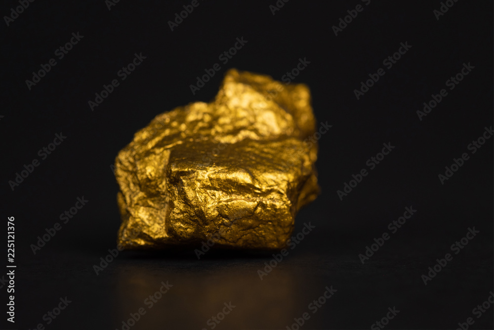 Closeup of gold nugget or gold ore on black background, precious stone or lump of golden stone, financial and business concept. Closeup of gold nugget or gold ore on black background, precious stone or lump of golden stone, financial and business concept.