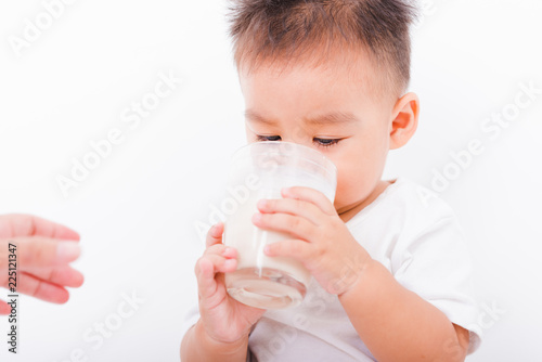Asian portrait child boys 1 year 6 months drinking milk on glass
