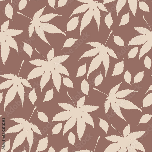 Seamless vector pattern with autumn leaves in silhouettes