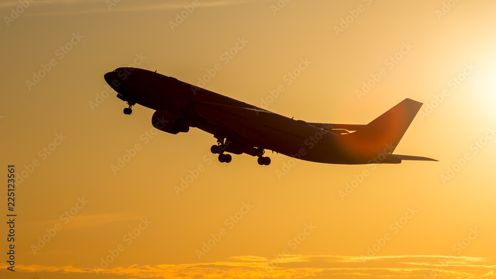 A flying airliner in the evening sky-a contour photography in the backlight. Contre-jour is a photographic technique in which the camera is pointing directly toward a source of light. A flying airliner in the evening sky-a contour photography in the backlight. Contre-jour is a photographic technique in which the camera is pointing directly toward a source of light.