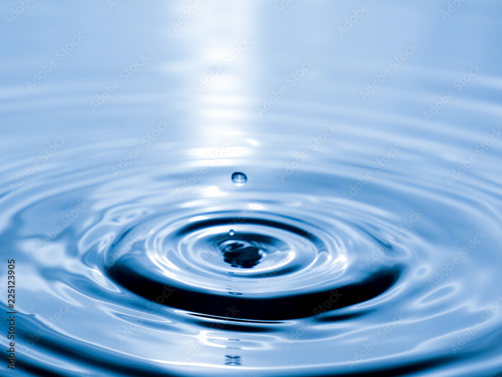 close up drop of water on blue background close up drop of water on blue background