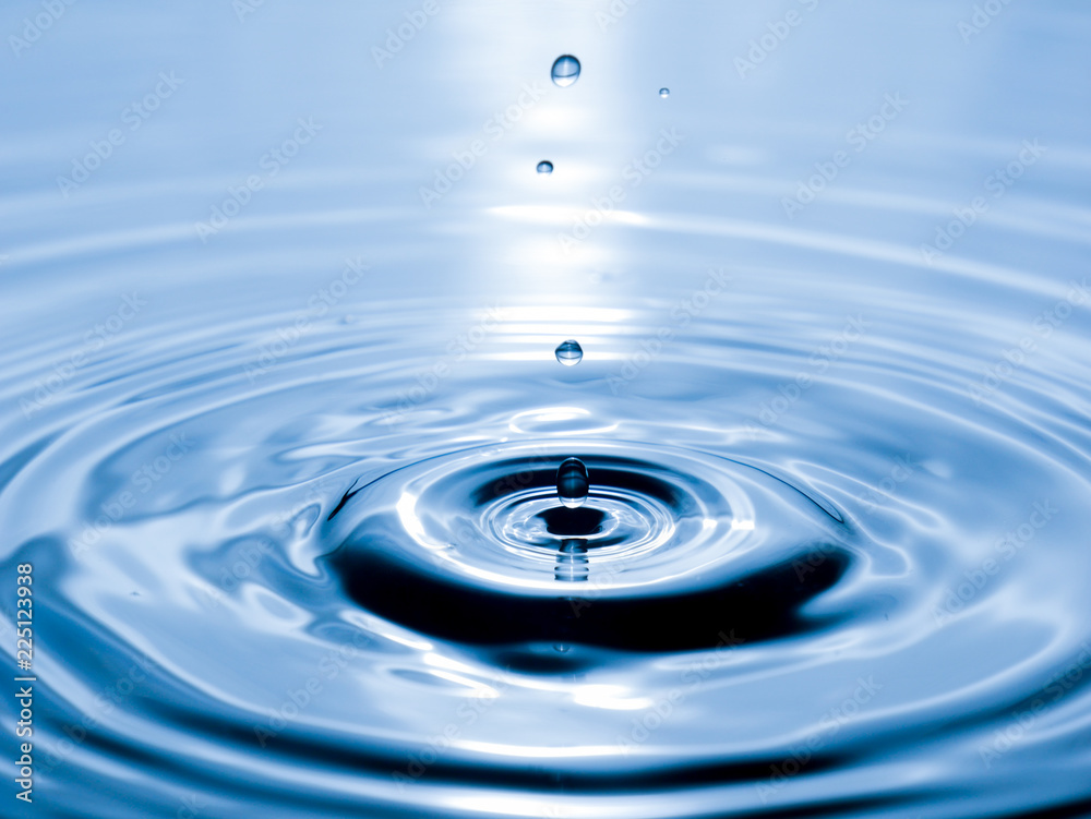 close up drop of water on blue background close up drop of water on blue background