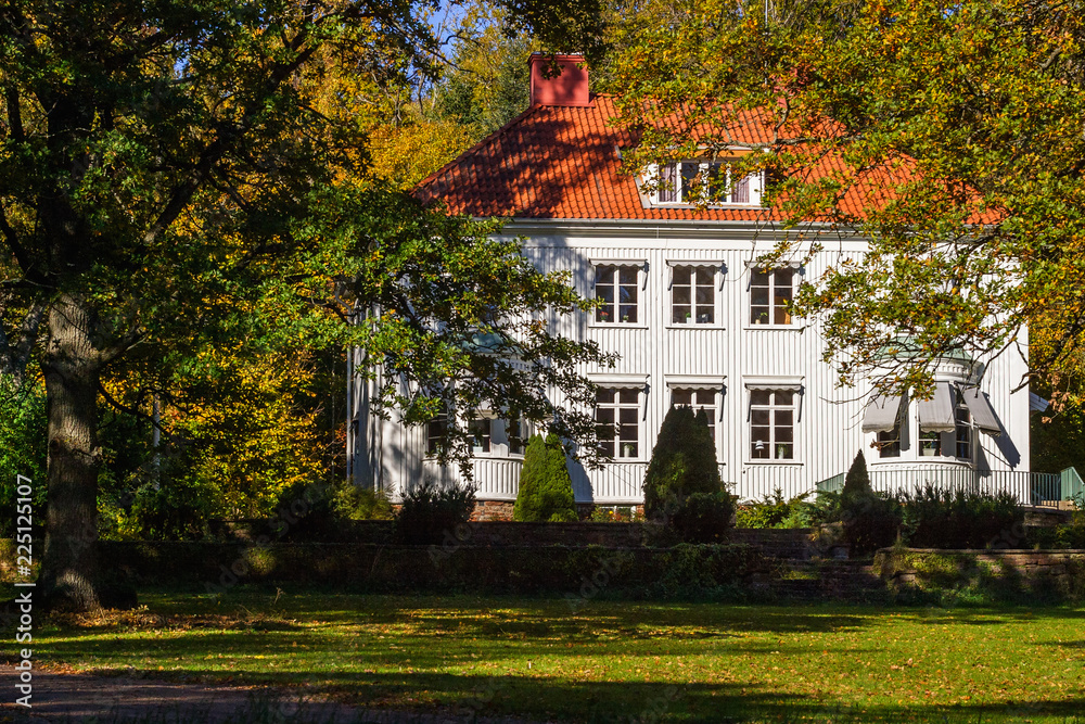 White big house with garden in the fall