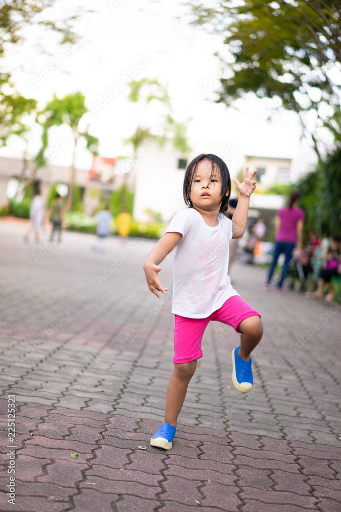 Little girl exercise by aerobic dance in the park