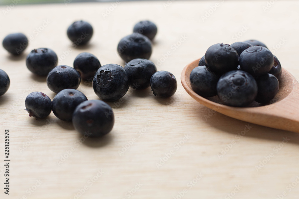 blueberry with wood spoon on wooden background. for healthy food concept. blueberry with wood spoon on wooden background. for healthy food concept.