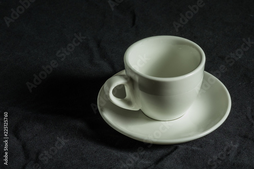  espresso coffee cup - white curved coffee cup with a thin porcelain pale for espresso coffee on a black background  original Italian design