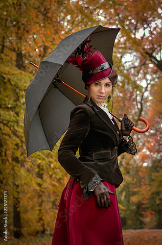 Beautiful woman with umbrella in the park