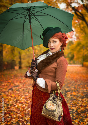 Beautiful woman with umbrella in the park