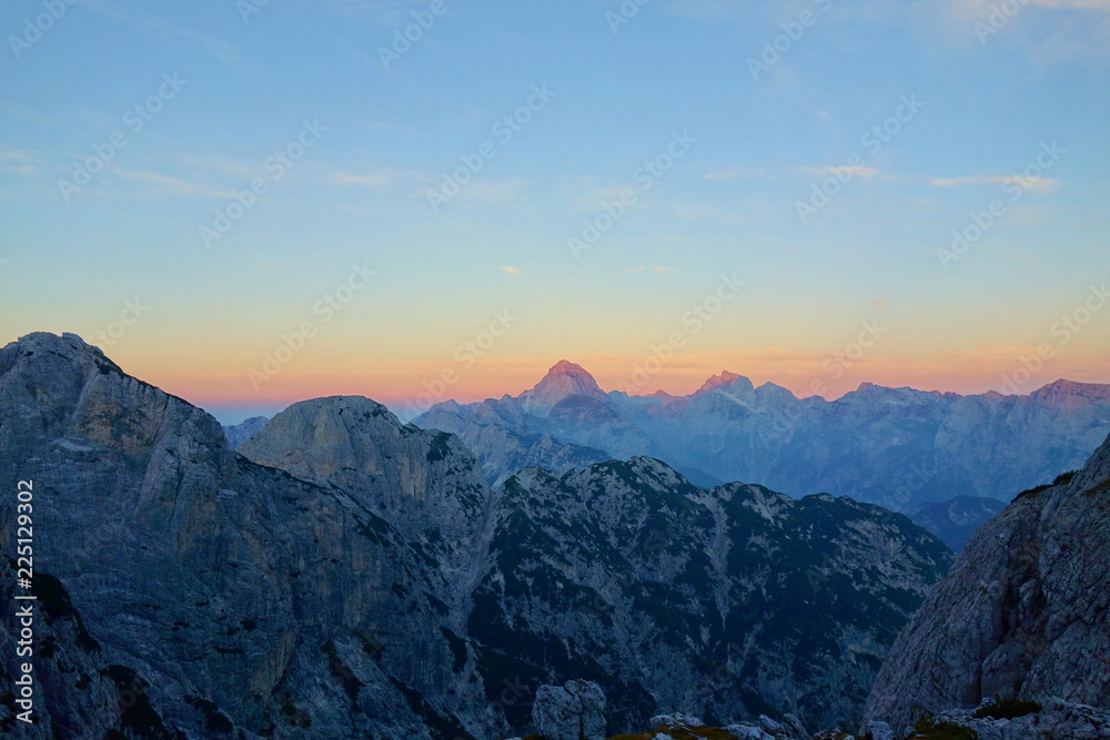 Sunset overlooking peaks of Dolomites in Italian Alps near to the border of Slovenia