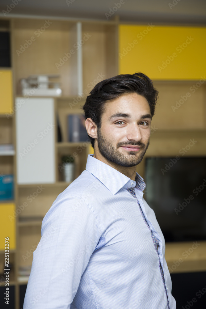 Happy young businessman smiling at the office Happy young businessman smiling at the office