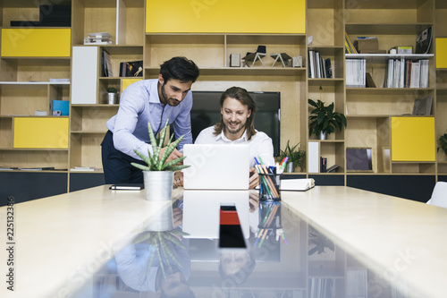 Two young businessmen worki...
