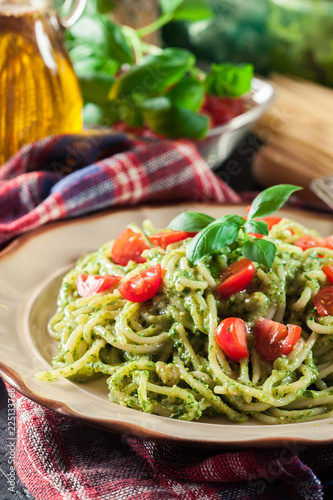 Vegetarian pasta spaghetti with basil pesto and cherry tomatoes