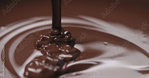 closeup pouring molten dark chocolate