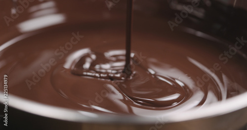 closeup pouring molten dark chocolate