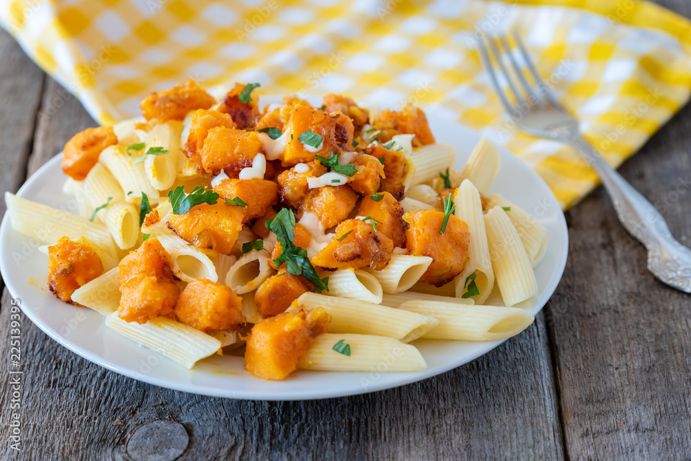 Penne pasta with pieces of fried pumpkin with onions and mozzarella Penne pasta with pieces of fried pumpkin with onions and mozzarella