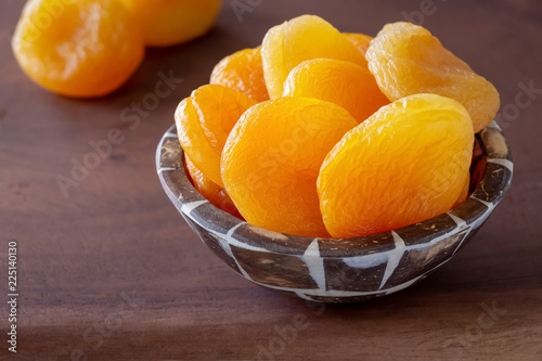 Turkish jumbo dried apricots in wooden bowl. Healthy snack concept.