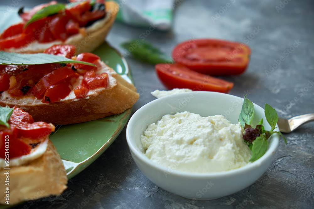 Italian bruschetta with chopped tomatoes, basil and cheese on grilled crusty bread Italian bruschetta with chopped tomatoes, basil and cheese on grilled crusty bread