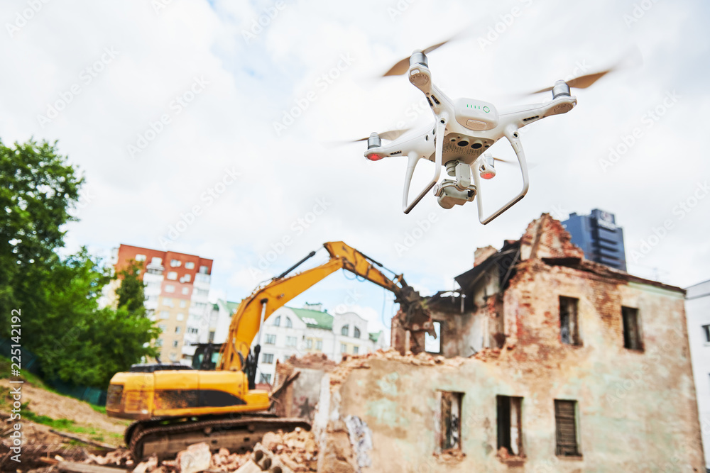 Drone operated by construction worker on building site Drone operated by construction worker on building site