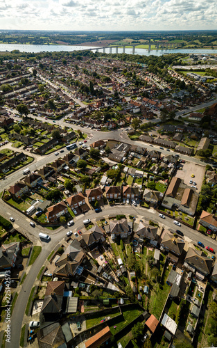 Vertical panoramic aerial view of suburban houses in Ipswich, UK. Orwell bridge and river in the background. Nice sunny day.