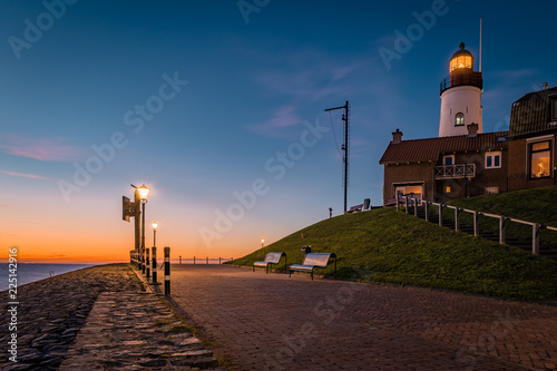 Urk ligthouse sunset lake ijsselmeer by Urk netherlands Flevolands former island of Urk photo