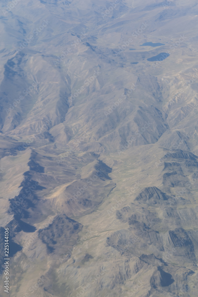 Fototapeta premium Aerial view of dry desert and the Andes Mountains somewhere over South America