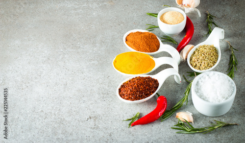 Fototapeta Naklejka Na Ścianę i Meble -  Spices in Wooden spoon. Curry, Saffron, turmeric, rosemary, cinnamon, garlic, pepper, anise on wooden rustic background. Collection of spices and herbs. Salt, paprika. Copy space. Top view. 