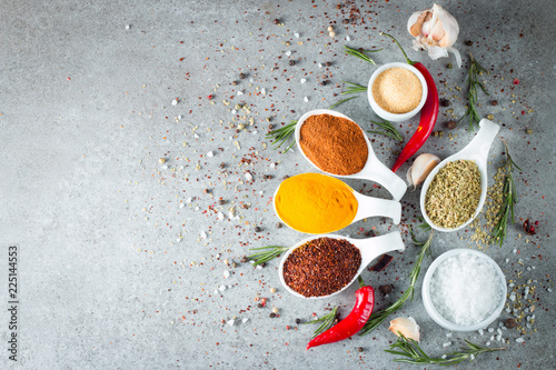Fototapeta Naklejka Na Ścianę i Meble -  Spices in Wooden spoon. Curry, Saffron, turmeric, rosemary, cinnamon, garlic, pepper, anise on wooden rustic background. Collection of spices and herbs. Salt, paprika. Copy space. Top view. 