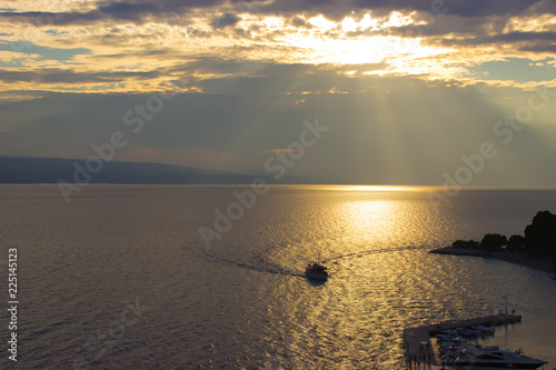 Fototapeta Naklejka Na Ścianę i Meble -  Ship at sea in sunshine at sunset