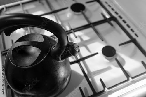 Old kettle on the gas stove in the kitchen