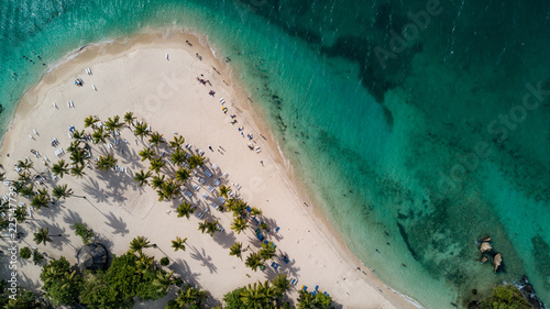 A breathtaking drone shoot glides over Cayo Levantado Beach in Samana, Dominican Republic, revealing a slice of paradise where powdery white sands meet crystal-clear turquoise waters. Nestled in the l