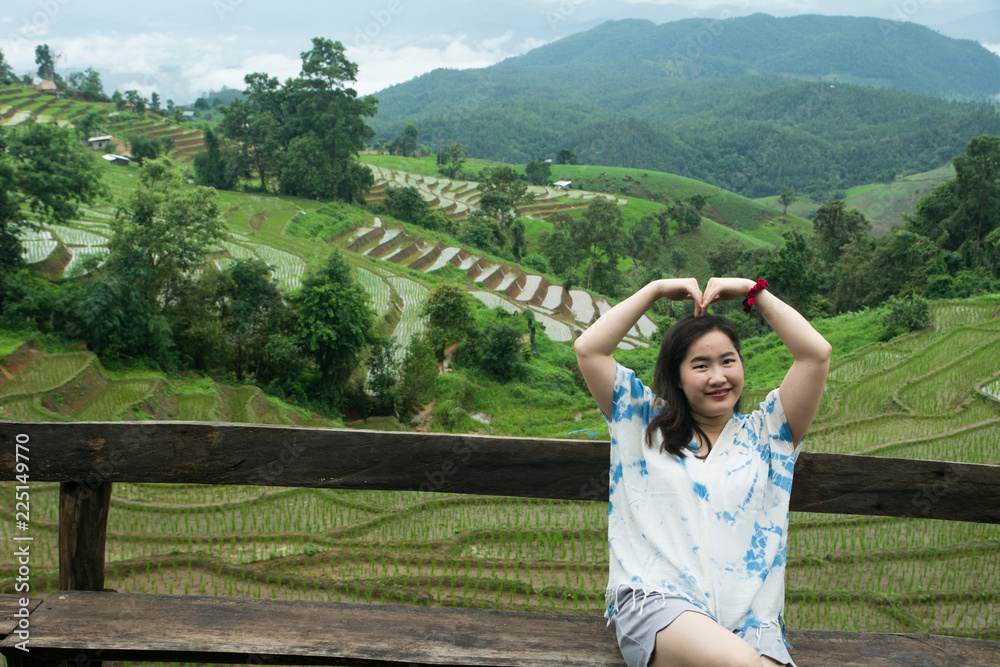 Fototapeta premium The pretty woman relaxing in holiday at rice terrace, Rice planting season in Chiang Mai, Tourism concept