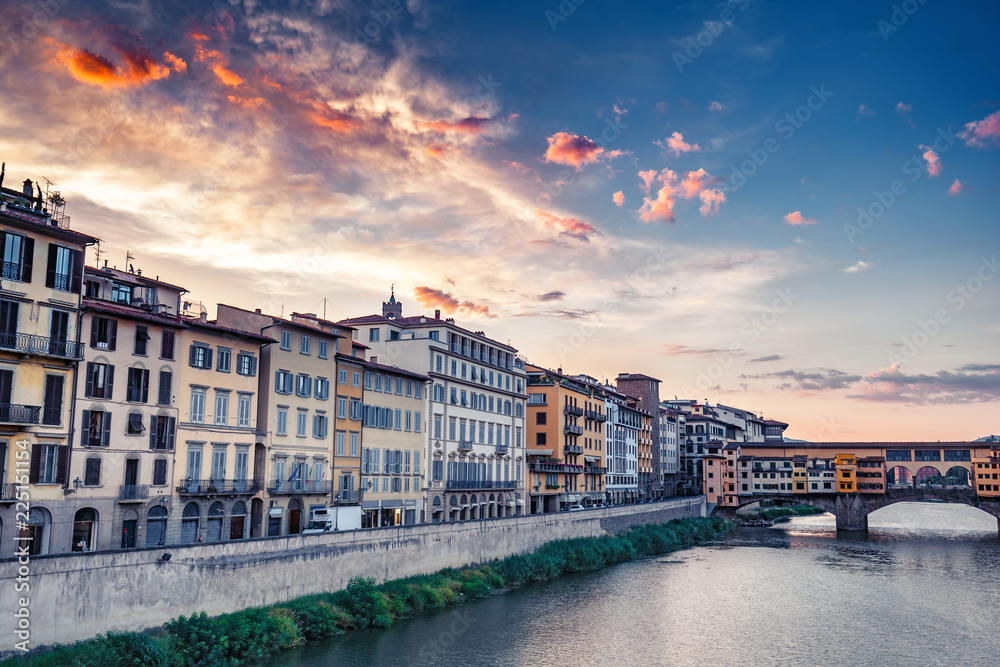 Sunrise over Ponte Vecchio in Florence, Italy, on a summer day. Colorful travel background.